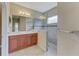 Bathroom features dual sinks, a large shower, and wood cabinets at 4807 Harvest Grove Pl, Parrish, FL 34219