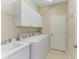 Laundry room with washer, dryer, and ample storage at 4807 Harvest Grove Pl, Parrish, FL 34219