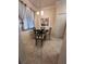 Small dining area with glass table and four chairs at 7005 River Hammock Dr # 404, Bradenton, FL 34212