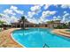 Community pool with plenty of lounge chairs at 7005 River Hammock Dr # 404, Bradenton, FL 34212