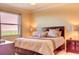 Large bedroom with king bed and window blinds at 7005 River Hammock Dr # 404, Bradenton, FL 34212