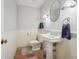 Small half bathroom with pedestal sink and wainscoting at 1411 70Th Nw St, Bradenton, FL 34209