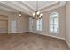 Elegant dining room featuring tile floors, a chandelier, and arched windows at 111 172Nd E St, Bradenton, FL 34212
