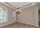 Bright dining room with tile floors, crown molding, and a chandelier at 111 172Nd E St, Bradenton, FL 34212