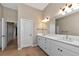 Double vanity bathroom with a quartz countertop and large mirror at 111 172Nd E St, Bradenton, FL 34212