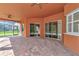 Covered patio with brick pavers and sliding glass doors at 111 172Nd E St, Bradenton, FL 34212