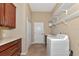 Laundry room with washer, dryer, cabinets, and shelving at 111 172Nd E St, Bradenton, FL 34212