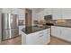 Modern kitchen island with granite countertop and white cabinets at 111 172Nd E St, Bradenton, FL 34212