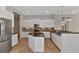 Modern kitchen with white cabinets, granite countertops, and stainless steel appliances at 111 172Nd E St, Bradenton, FL 34212
