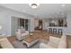 Open living room with white sofas and a large TV at 111 172Nd E St, Bradenton, FL 34212