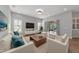 Bright living room with white sofas and sliding doors at 111 172Nd E St, Bradenton, FL 34212