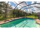 Inviting screened pool with a spa and a fenced backyard at 111 172Nd E St, Bradenton, FL 34212