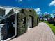 Side view of house showcasing a lush green wall and brick detail at 1303 51St W St, Bradenton, FL 34209