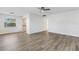 Bright living room with wood-look floors and ceiling fan at 1902 Andover St # 213, Sun City Center, FL 33573