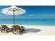 Relaxing beach scene with lounge chairs and umbrella at 2244 Palm Ter, Sarasota, FL 34231