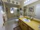 Well-lit bathroom featuring a shower/tub combo and yellow cabinets at 6812 11Th W Ave # 6812, Bradenton, FL 34209