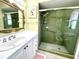Clean bathroom featuring a vanity with a unique mirror and a fully enclosed tiled shower at 6812 11Th W Ave # 6812, Bradenton, FL 34209