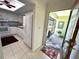 White kitchen featuring a skylight, black countertops, modern appliances, and view to front door at 6812 11Th W Ave # 6812, Bradenton, FL 34209