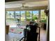 Bright lanai featuring tile floor, ceiling fan, and view of the community pool at 6812 11Th W Ave # 6812, Bradenton, FL 34209