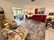 Inviting living room showcases a floral-patterned chair and an open floorplan, brightened by natural light at 6812 11Th W Ave # 6812, Bradenton, FL 34209