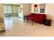 Bright living room with tile floors, floral armchairs, a red sofa and view to a sunroom at 6812 11Th W Ave # 6812, Bradenton, FL 34209