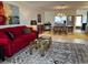 Cozy living room featuring a red sofa, stylish area rug, and an adjacent dining area with seating at 6812 11Th W Ave # 6812, Bradenton, FL 34209