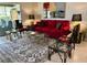 Cozy living room showcasing a red sofa, glass coffee table, and stylish decor on a tile floor with rug at 6812 11Th W Ave # 6812, Bradenton, FL 34209