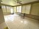Bright sun room with tile floors, fan, and lots of natural light from numerous windows at 6812 11Th W Ave # 6812, Bradenton, FL 34209