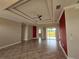 Spacious living room with tile flooring and a tray ceiling at 434 Perdido St, North Port, FL 34287