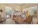 Bright dining room features a large table, access to kitchen and pool views at 1887 Buccaneer Cir, Sarasota, FL 34231