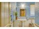 Bathroom with pedestal sink, light blue walls, and a shower/tub combo at 1887 Buccaneer Cir, Sarasota, FL 34231