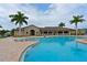 Inviting community pool with spacious deck and lounge chairs at 7114 Quiet Creek Dr, Bradenton, FL 34212