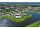 Aerial view of community pool, clubhouse, and tennis courts at 7114 Quiet Creek Dr, Bradenton, FL 34212