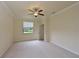 Spacious bedroom with ceiling fan and large window at 7114 Quiet Creek Dr, Bradenton, FL 34212
