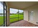Screened lanai overlooking a pond and lush landscape at 7114 Quiet Creek Dr, Bradenton, FL 34212