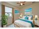 Bedroom with ceiling fan, window, and coastal decor at 7114 Quiet Creek Dr, Bradenton, FL 34212