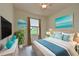 Bright bedroom with window, ceiling fan, and coastal decor at 7114 Quiet Creek Dr, Bradenton, FL 34212