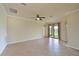 Spacious living room featuring tile floors and sliding glass doors at 7114 Quiet Creek Dr, Bradenton, FL 34212