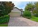 Beautiful home exterior with a paved driveway and lush landscaping at 7114 Quiet Creek Dr, Bradenton, FL 34212
