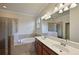 Bathroom with double vanity, soaking tub, and separate shower at 7114 Quiet Creek Dr, Bradenton, FL 34212