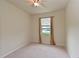 Bright bedroom with neutral walls and carpeting, featuring a window with lake view at 7114 Quiet Creek Dr, Bradenton, FL 34212