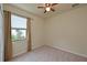 Simple bedroom with window and ceiling fan at 7114 Quiet Creek Dr, Bradenton, FL 34212