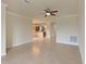 Open living room with tile floors, neutral walls, and kitchen view at 7114 Quiet Creek Dr, Bradenton, FL 34212
