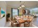 Elegant dining room with a large wooden table and wicker chairs at 7114 Quiet Creek Dr, Bradenton, FL 34212