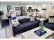 Open living space features a navy blue sofa and a view into the kitchen at 2244 Palm Ter, Sarasota, FL 34231
