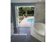 Spa-like bathroom with soaking tub and access to the pool at 2244 Palm Ter, Sarasota, FL 34231