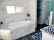 Spa-like bathroom with a large soaking tub, walk-in shower, and double vanity at 2244 Palm Ter, Sarasota, FL 34231