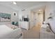 Bedroom with a queen-size bed, dresser, armchair, and artwork at 383 Aruba Cir # 101, Bradenton, FL 34209