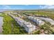 Aerial view of waterfront community with multiple buildings and lush landscaping at 383 Aruba Cir # 101, Bradenton, FL 34209