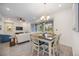 Elegant dining area with table and chairs, open to living room at 383 Aruba Cir # 101, Bradenton, FL 34209